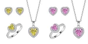 Detail view of heart-cut yellow and pink 925 silver jewelry sets with sparkling halo pavé