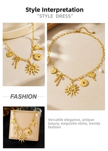 Detail of gold chunky necklace with sun, evil eye, heart pendants and white pearls