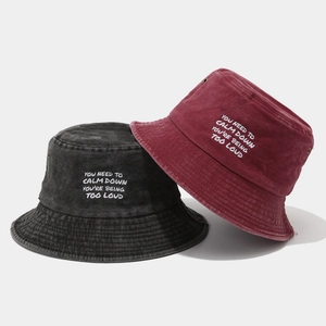 Washed cotton bucket hats in grey and burgundy with white text embroidery
