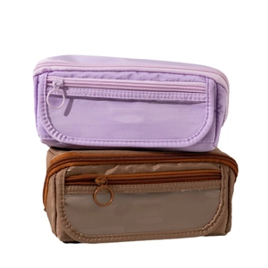 Minimalist nylon pencil cases in purple and brown with clear windows and dual metal ring zippers