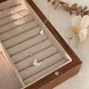 Elegant 925 sterling silver choker necklace with butterfly pendants in a wooden jewelry box