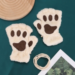 Detailed plush texture of cream cat paw gloves with soft brown padding for winter