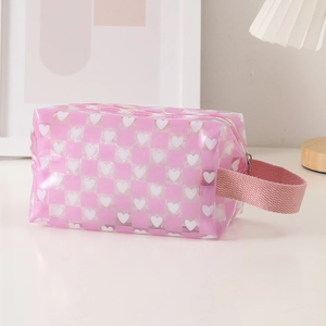 Macro view of the pink heart checkerboard pencil case featuring a side handle strap