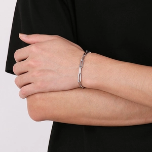 Close-up of a silver paperclip chain bracelet on a wrist for a hip-hop unisex look