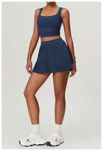 Navy blue two-piece yoga set with U-neck crop top and pleated tennis skirt detail