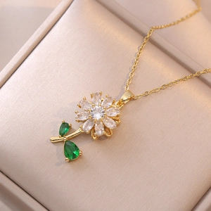 Rotating flower pendant necklace in gold stainless steel with green leaf and white petals