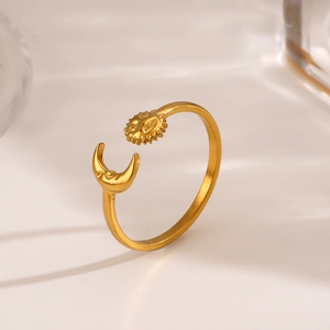 Gold stainless steel open ring with celestial sun and moon design on light background