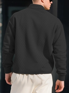 Rear view of black textured jacquard long sleeve polo shirt with diamond geometric pattern