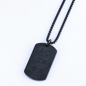 Macro shot of black dog tag necklace featuring engraved Knight's armor elements