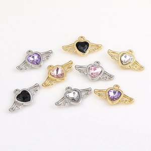 Eight angel wing heart pendants with gold and silver bases and colorful gemstones