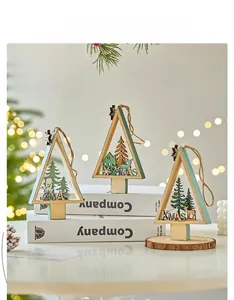 Detail of wooden Christmas ornaments with snowman and reindeer laser-cut scenes