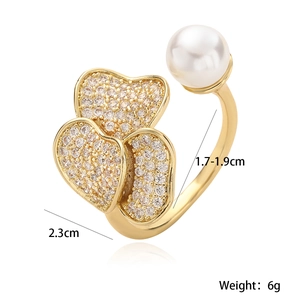 Detailed view of gold plated ring with zircon hearts, white pearl and dimension markings