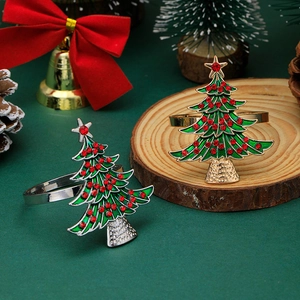 Detail of Christmas tree napkin rings with green enamel and sparkling red rhinestones