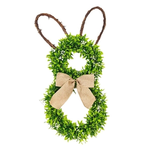 Close-up of Easter rabbit wreath featuring green leaves, vine ears, and burlap bow detail