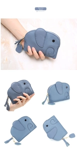 Close-up of denim blue leather elephant coin purse showing pebble grain texture and tassel