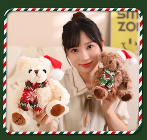Detail of cute beige and brown teddy bears wearing red Christmas hats and festive scarves