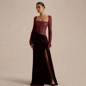 Close-up of lace bodice and burgundy velvet fabric on a high-slit evening dress