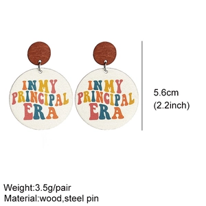 Detail of wooden earrings with 'IN MY PRINCIPAL ERA' text and 5.6cm size measurements