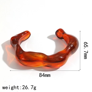 Detailed view of amber resin bangle showing dimensions 65.7mm height and 84mm width