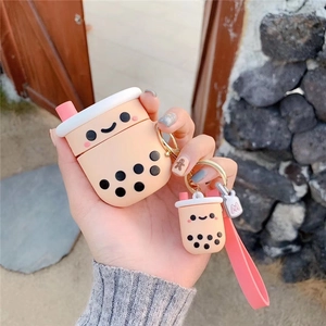 Detail of cute milk tea cup silicone case with pink strap held against outdoor background