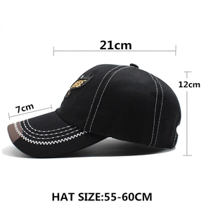 Black cotton baseball cap with white stitching and gold eagle wing logo and size chart