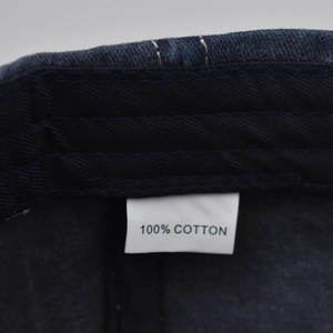 Detailed close-up of 100% cotton fabric and wash label inside the vintage baseball cap