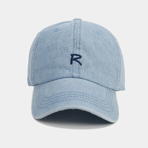Detail view of denim baseball cap featuring premium navy blue R letter embroidery