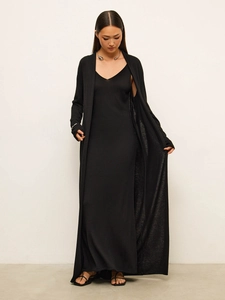 Detail of soft black knit fabric texture on long-sleeve cardigan and matching slip dress