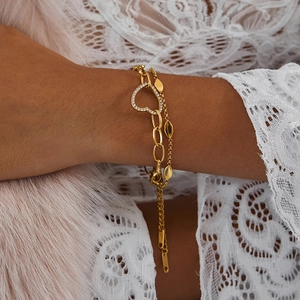 Detail of 18K gold-plated double-layer bracelet with sparkling heart charm and marquise links
