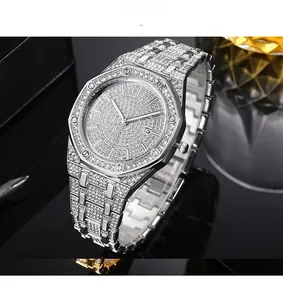 Macro view of full crystal encrusted silver watch with octagonal bezel and date window