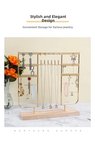 Detailed view of golden metal jewelry stand with wooden base for earrings and necklaces