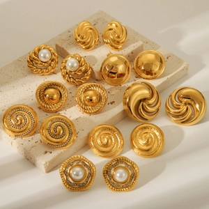18K gold plated stainless steel spiral and pearl earrings collection on stone base