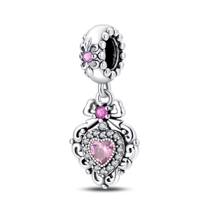 Close-up of silver pendant featuring a pink heart gem and delicate floral bow charms
