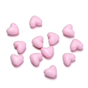 Close-up of pink heart-shaped acrylic beads for DIY handmade jewelry and craft accessories