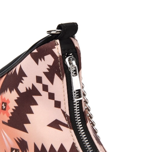 Close-up of bohemian canvas bag with pink geometric ethnic patterns and silver metal zipper