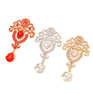 Baroque style pendants featuring ruby and crystal stones with intricate filigree metalwork