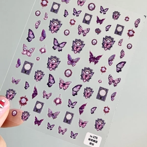 Detail of purple butterfly nail art stickers with vintage patterns on transparent film