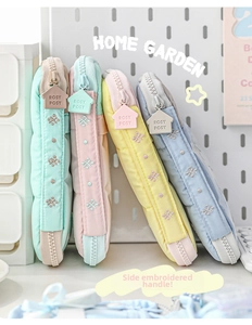 Side view of multi-color RosyPosy storage bags with thick handles and embroidered details