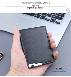 Close-up of black leather card holder with litchi texture and silver metal corner detail