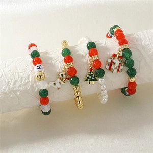 Close-up of 4-piece Christmas beaded bracelets with festive charms and MERRY XMAS letters
