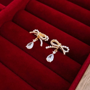 Elegant gold-plated bow earrings with imitation pearls and teardrop zircon pendants