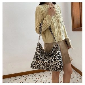 Fashionable leopard print large capacity tote bag shown on model in a modern interior