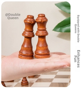 Detail of two solid walnut wood chess queens with glossy finish and natural wood grain
