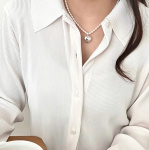Elegant 925 sterling silver heart pearl necklace shown on a model for a minimalist look