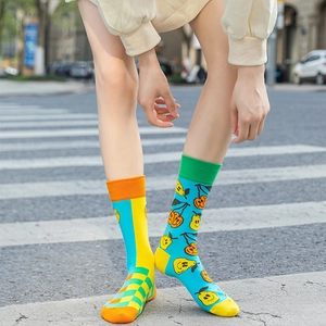 Detail of colorful mismatched cotton crew socks with fruit patterns and plaid design