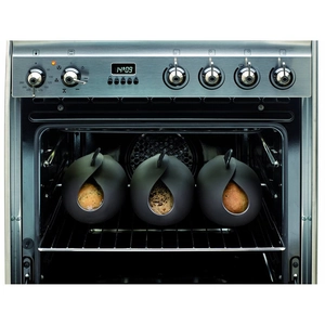 Black silicone fish steamer and bread maker showing three pods baking in an oven