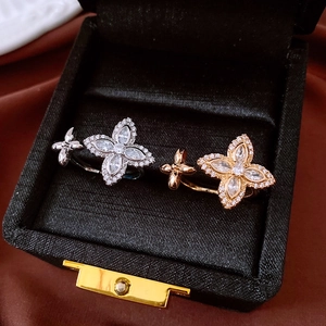 Detail shot of gold and silver flower rings with micro-set zircon in a luxury jewelry box