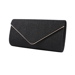 Close-up of black glitter evening clutch with elegant gold V-shaped metal trim detail