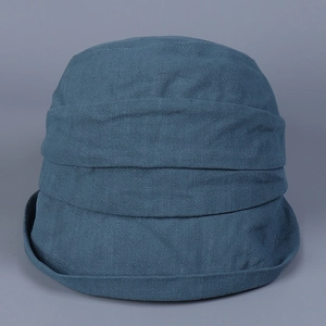 Detail view of navy blue cotton linen sun hat featuring pleated texture and fine stripes