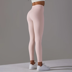 Detail view of pink high-waist yoga leggings showing elastic fabric and body-shaping fit